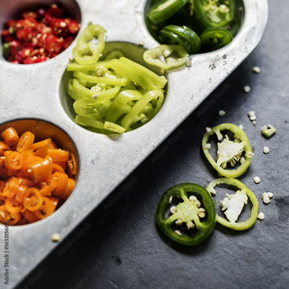 Closeup of cut chili peppers in metal tray