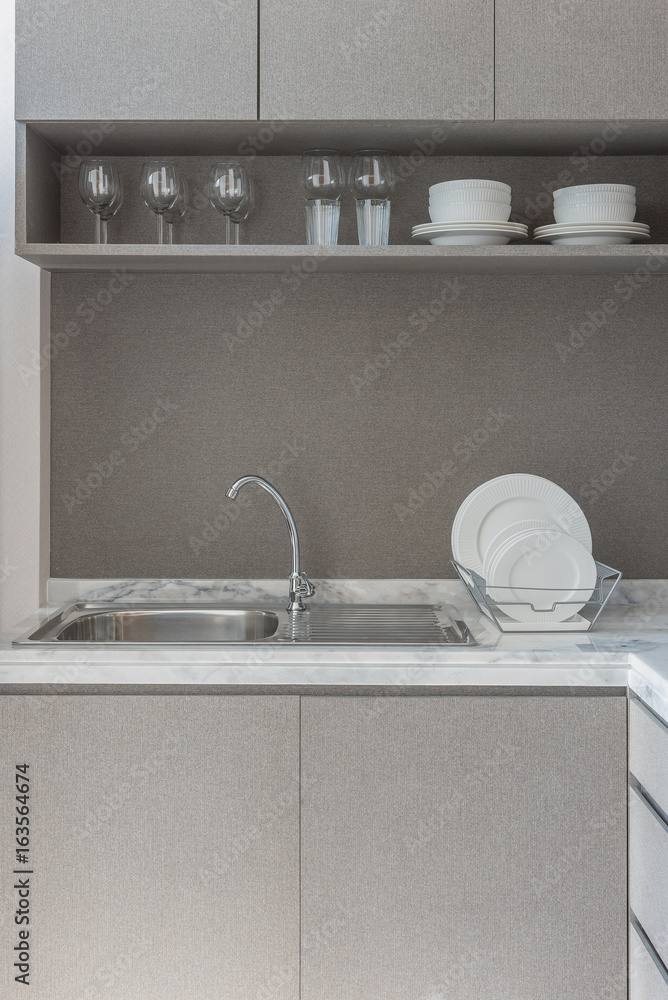 modern kitchen room with sink on granite counter top