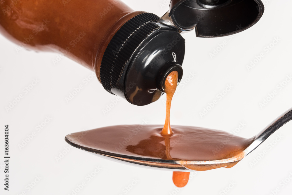 Pouring Hot Sauce on a Spoon