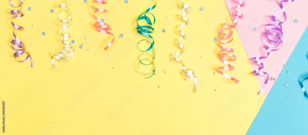 Party streamers on a bright split tone background