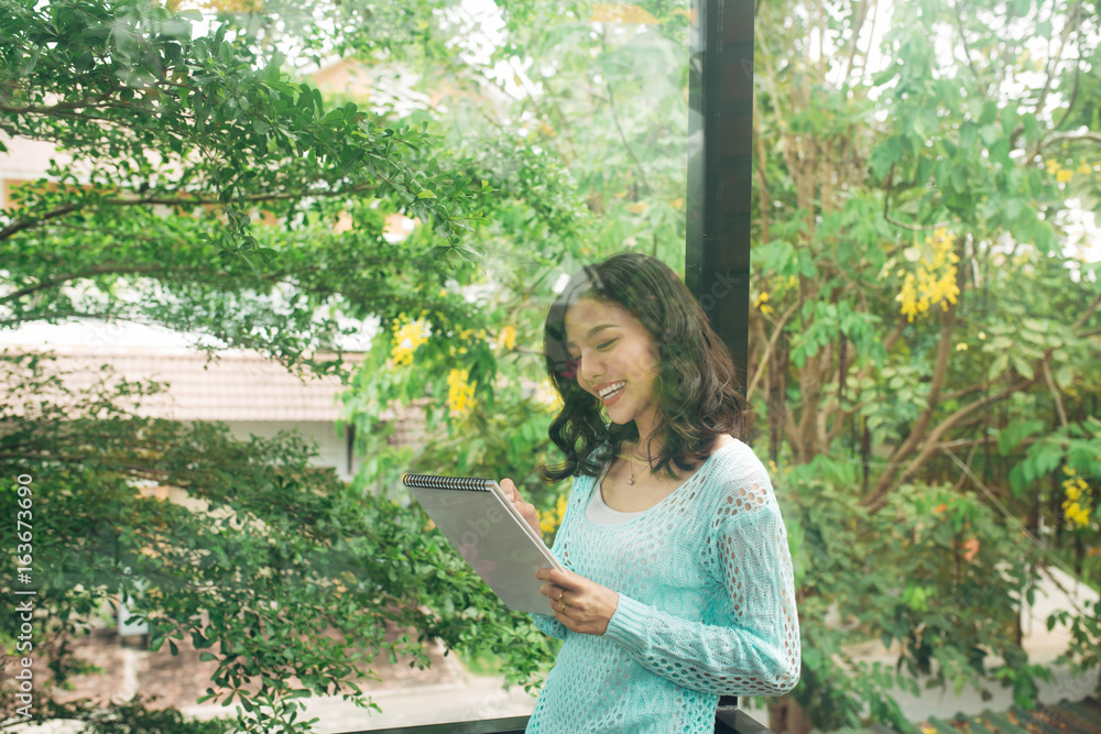 Author, Typewriter, Journalist. Intelligent woman standing on balcony and thinking