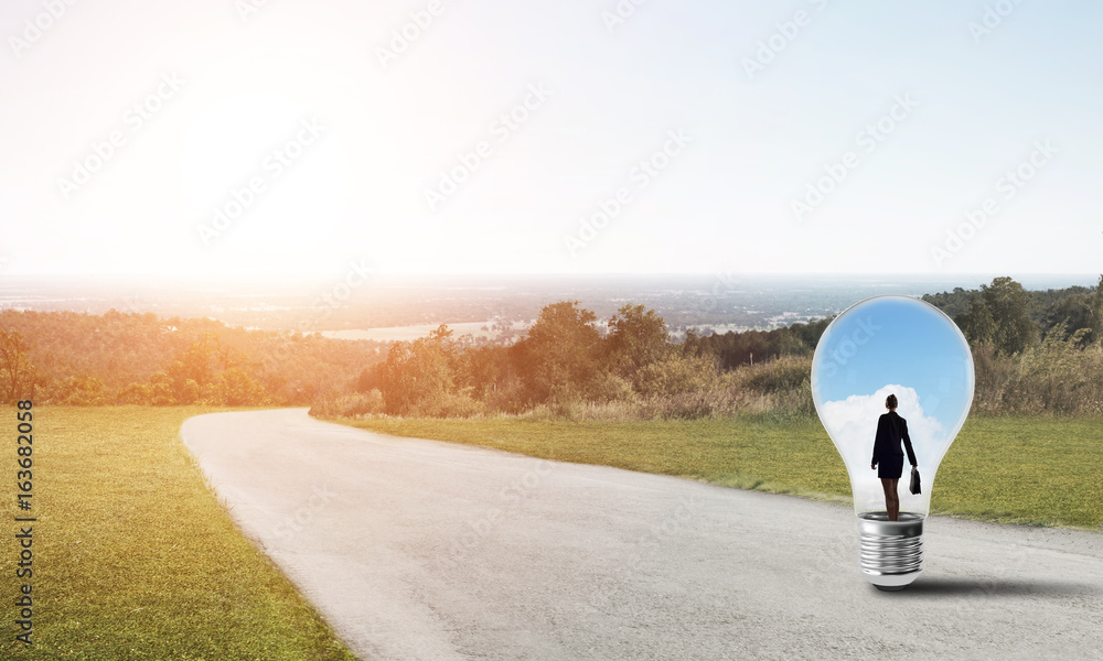 Businesswoman inside light bulb