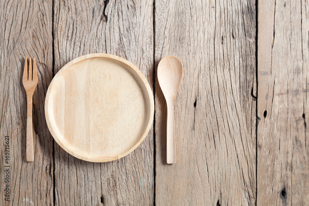 wooden spoon and wooden plate on old wood table background,copy space for your product and cooking d