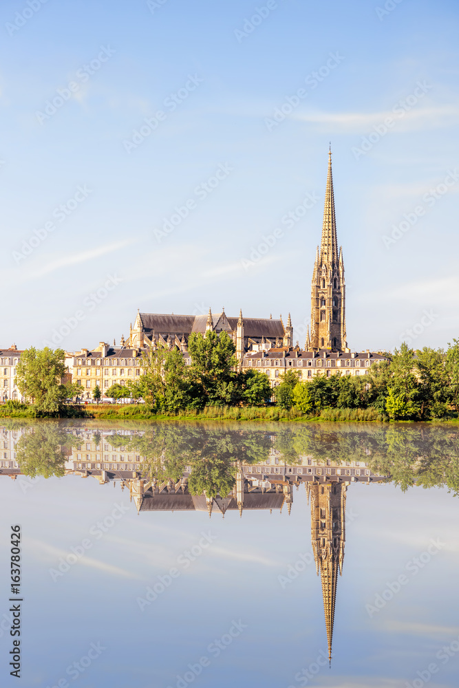 Riverside view on Garonne river with saint Michel cathedral in Bordeaux city, France