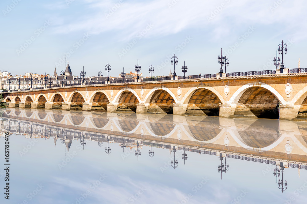 View on the famous saint Pierre bridge with reflection on the water in Bordeaux city, France