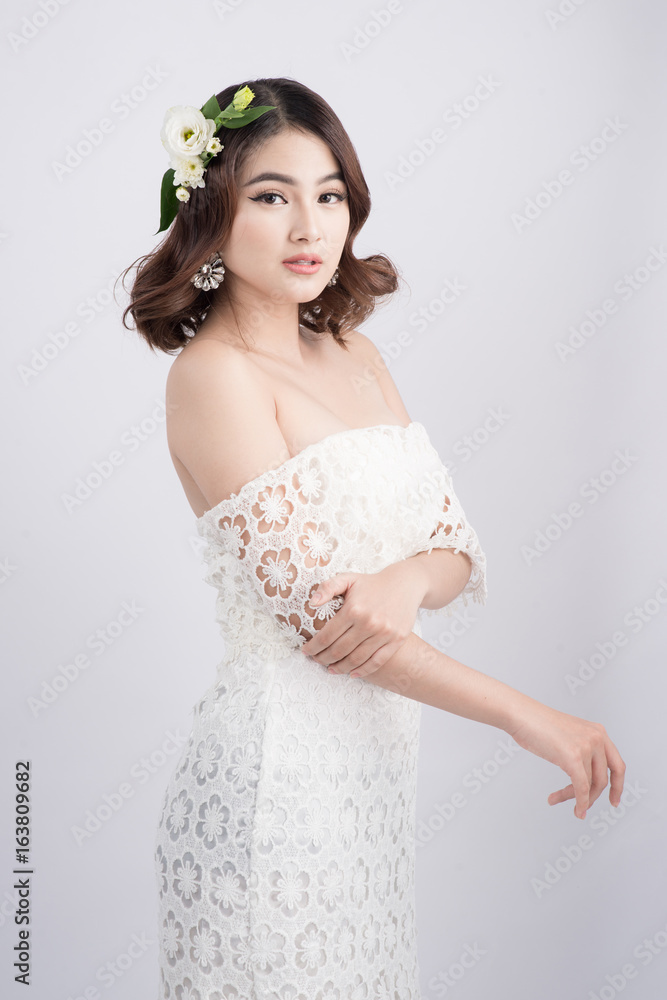 Beautiful asian woman bride on grey background. Closeup portraits with a professional makeup