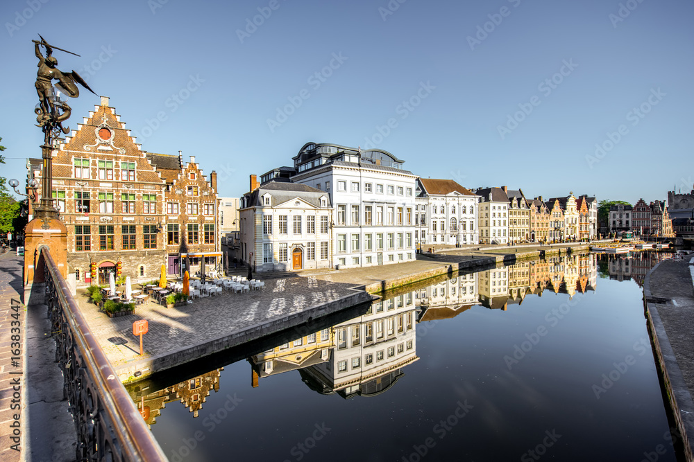 Riverside view with beautiful old buildings and water channel during the morning light in Gent city,