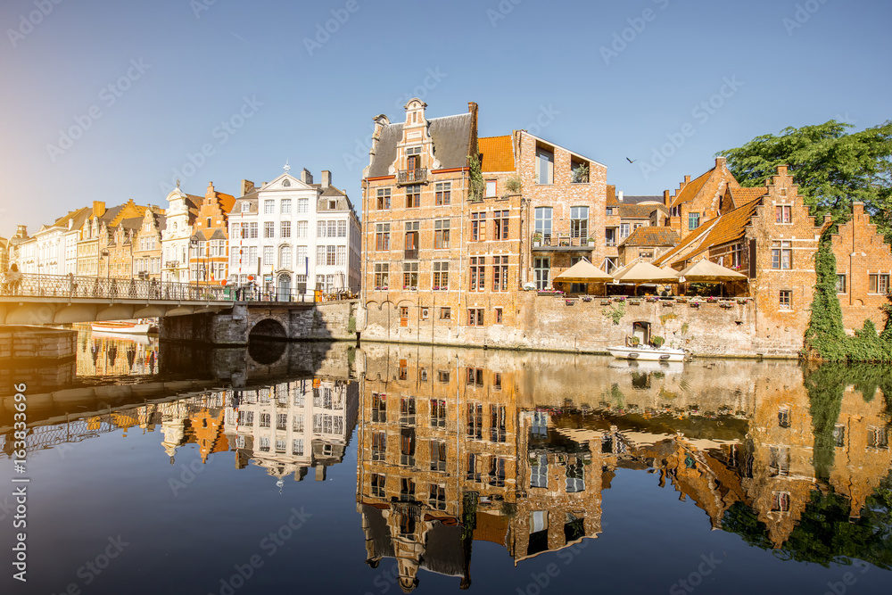 Riverside view with beautiful old buildings and water channel during the morning light in Gent city,