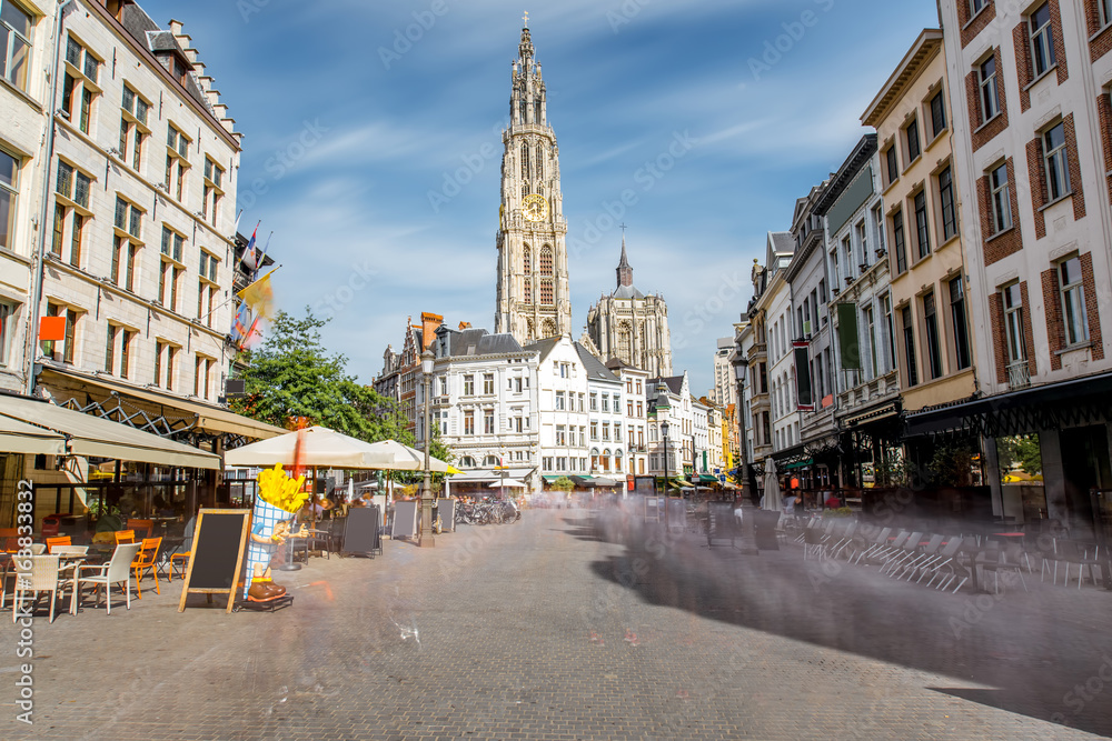 Street view with Our Lady church tower in the center of Antwerpen city, Belgium. Long exposure image