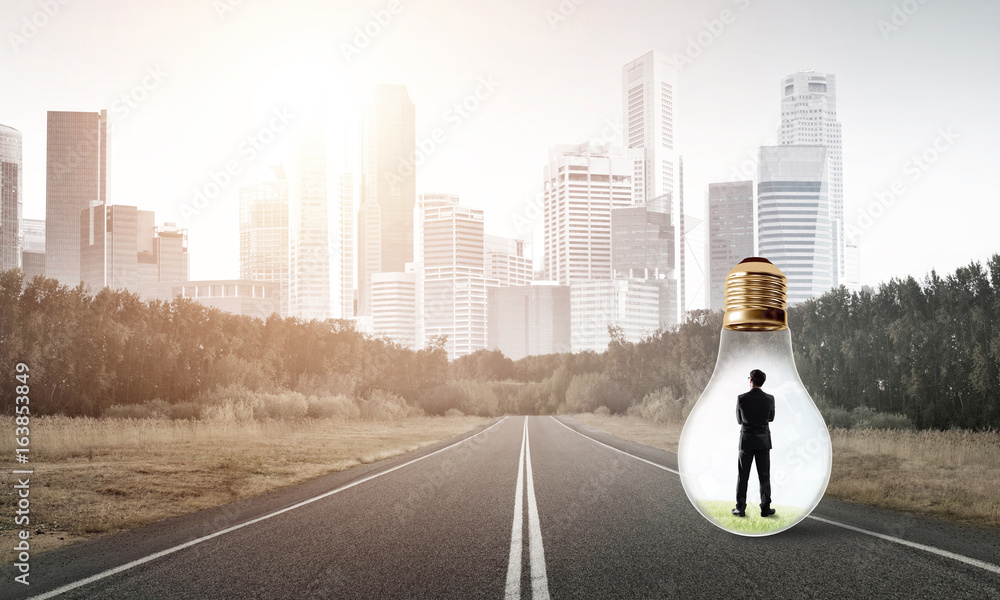 Businessman inside light bulb