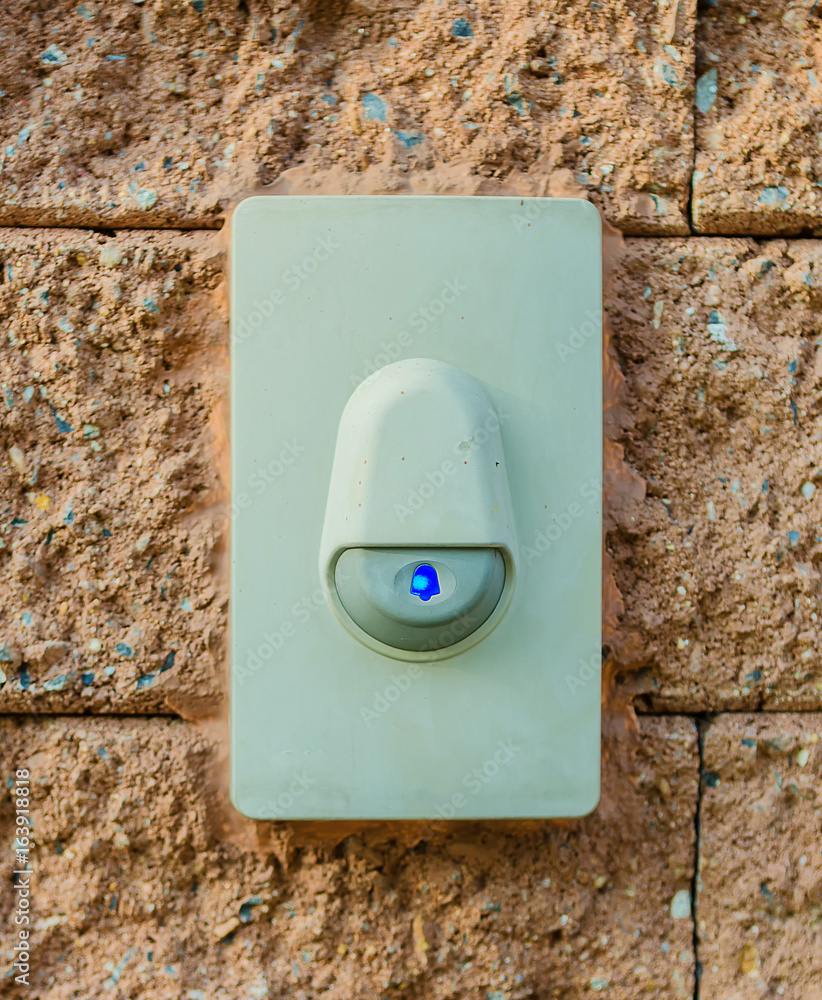 The ring is attached to the wall of the brick house.