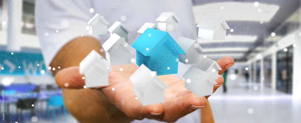 Businessman using 3D rendered small white and blue houses