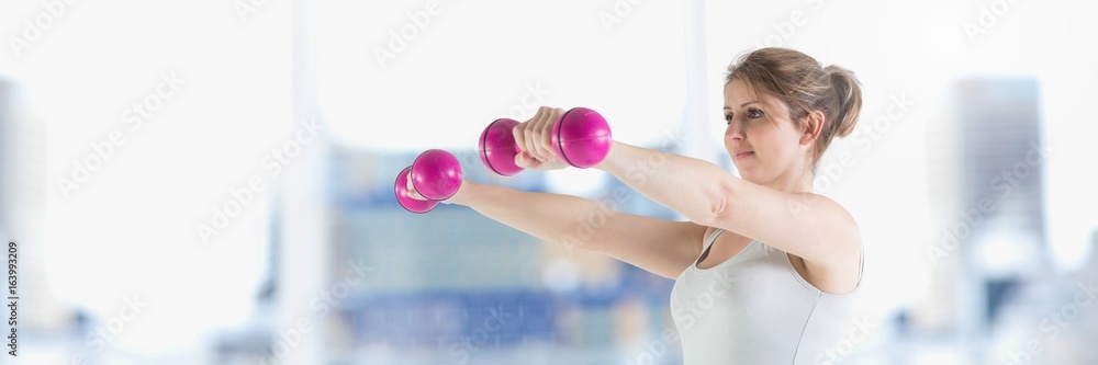 Slim healthy woman lifting weights