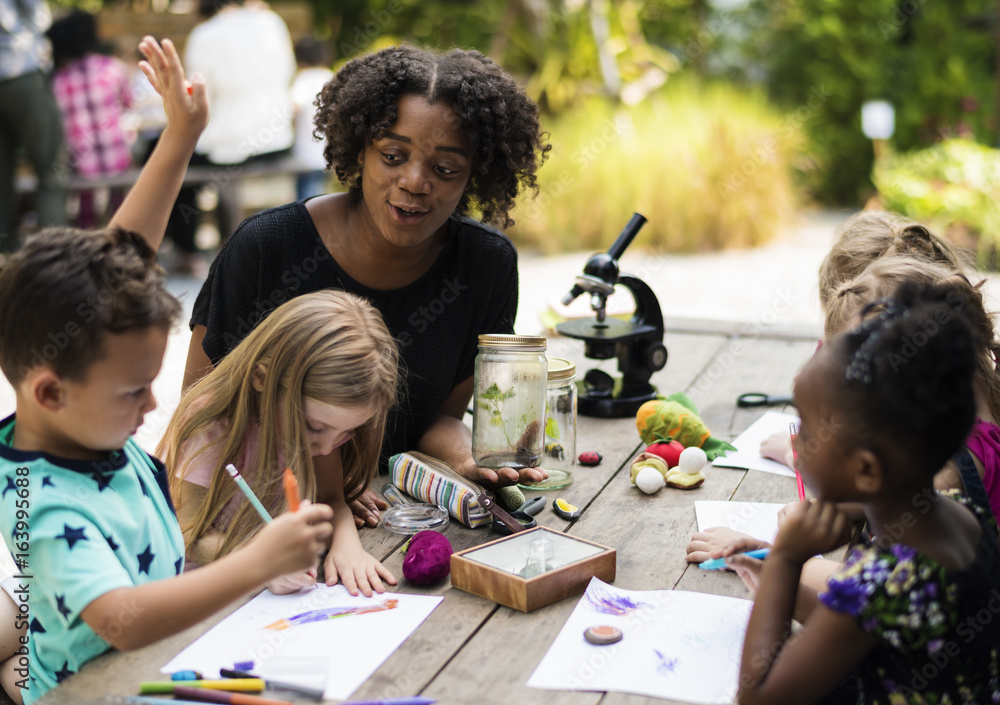 Group of kids classmates learning biology drawing class