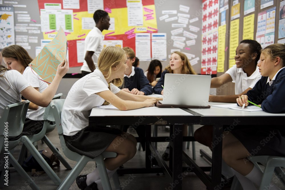 Group of students learning in classroom