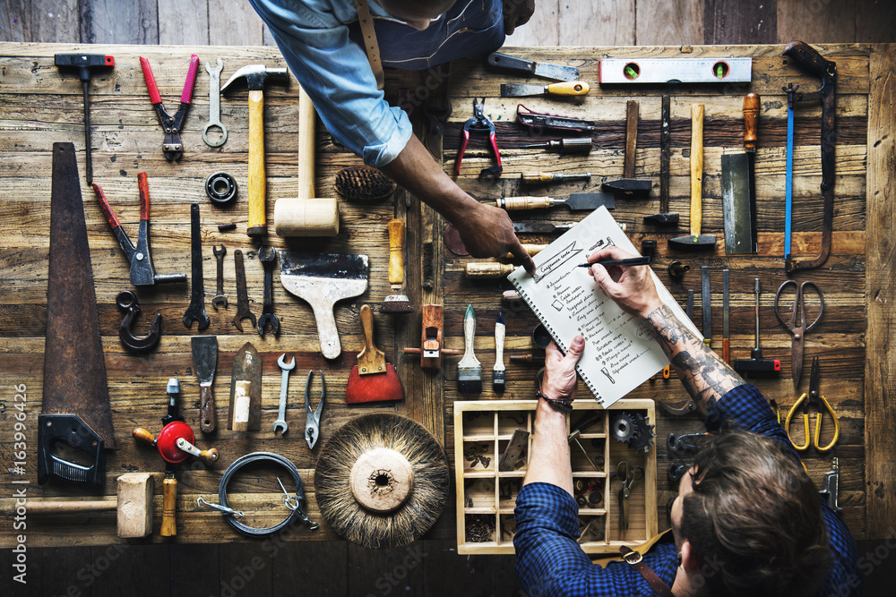 Aerial view of carpenter man listing checking tools equipment