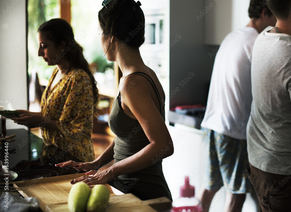 Group of diverse friends preparing barbecue in the kitchen together