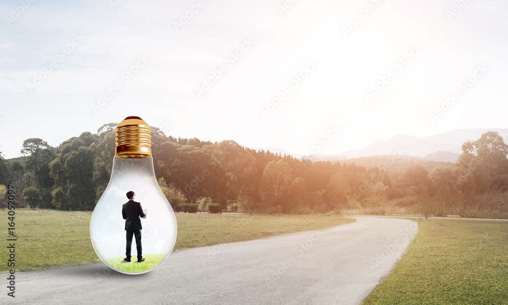 Businessman inside light bulb