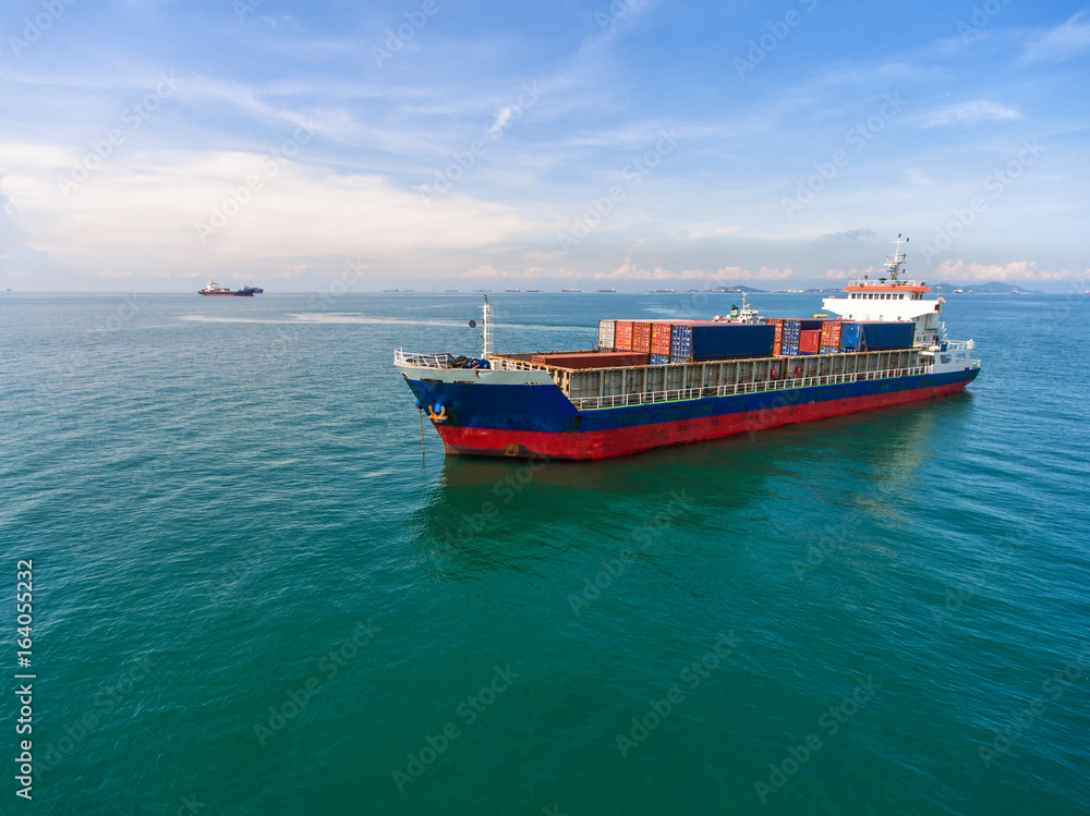 container ship in import export and business logistic.By crane , Trade Port , Shipping.Tugboat assis