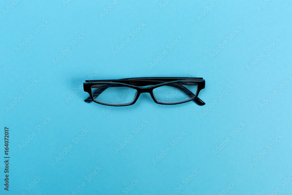 A pair of glasses on a bright blue background