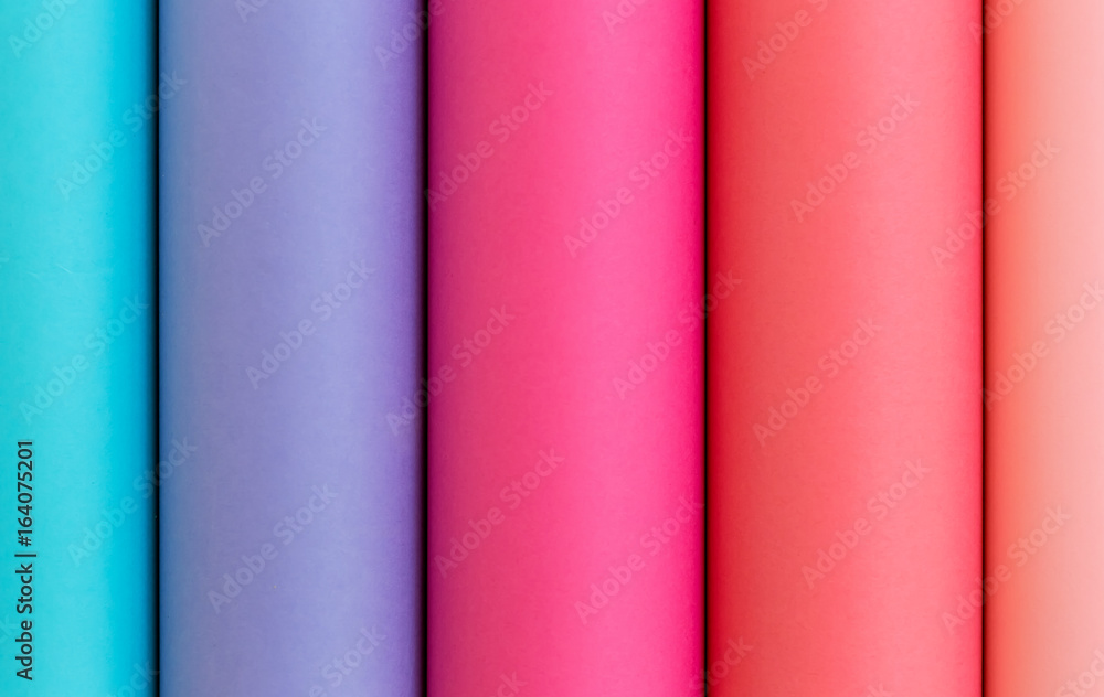 Colorful bright rolls of a paper arranged in a row