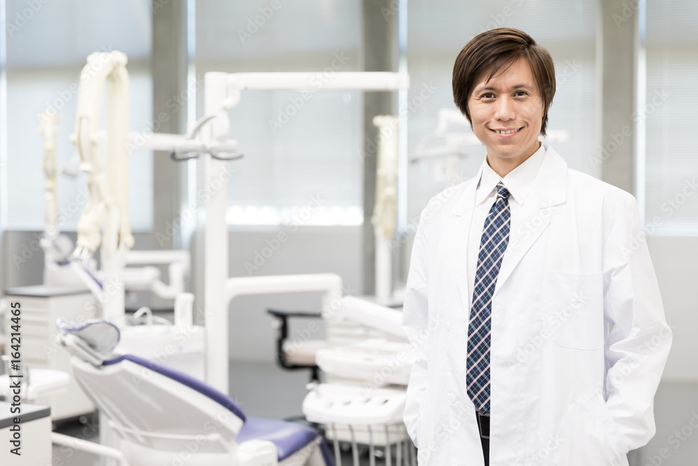 portrait of asian dentist in dental clinic