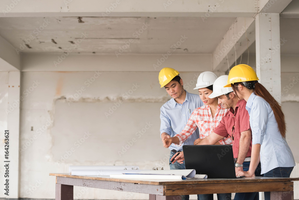 Four construction engineer working on blue print in side building plan for renovation, construction 