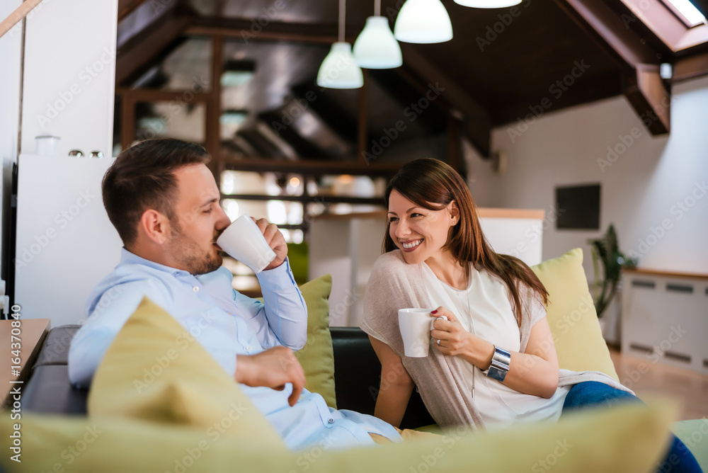 Happy young couple having fun on the sofa