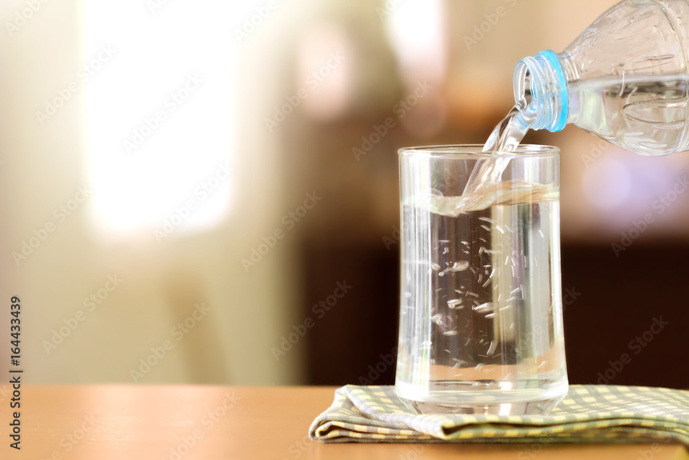 The Glass of the purified water on the table bar in kitchenroom