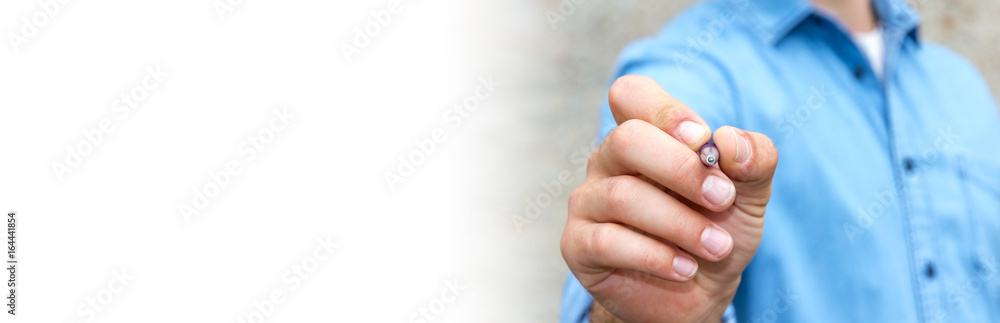 Panorama view of a businessman writing with a pen