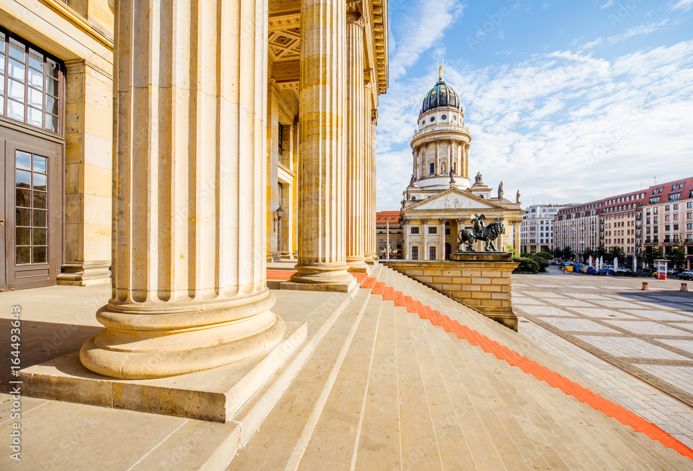 Viiew on the columns of the concert house building with German cathedral on the background during th