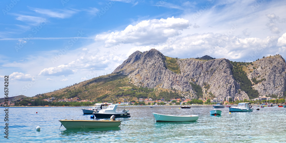 Coastal town of Omis surrounded with mountains in Croatia, Croatian travel landmark at Adriatic sea