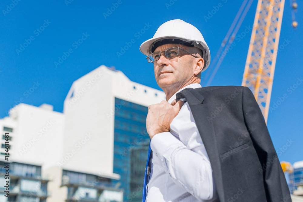 夏日阳光明媚，身着西装的高级优雅建筑工人在施工现场