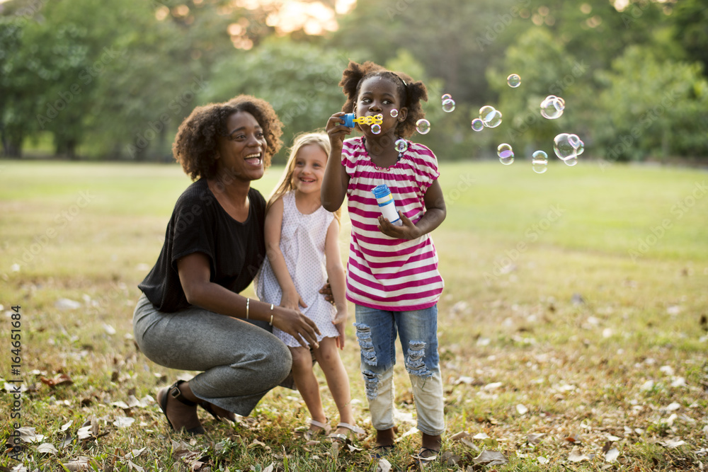 Children is playing bubbles in a park