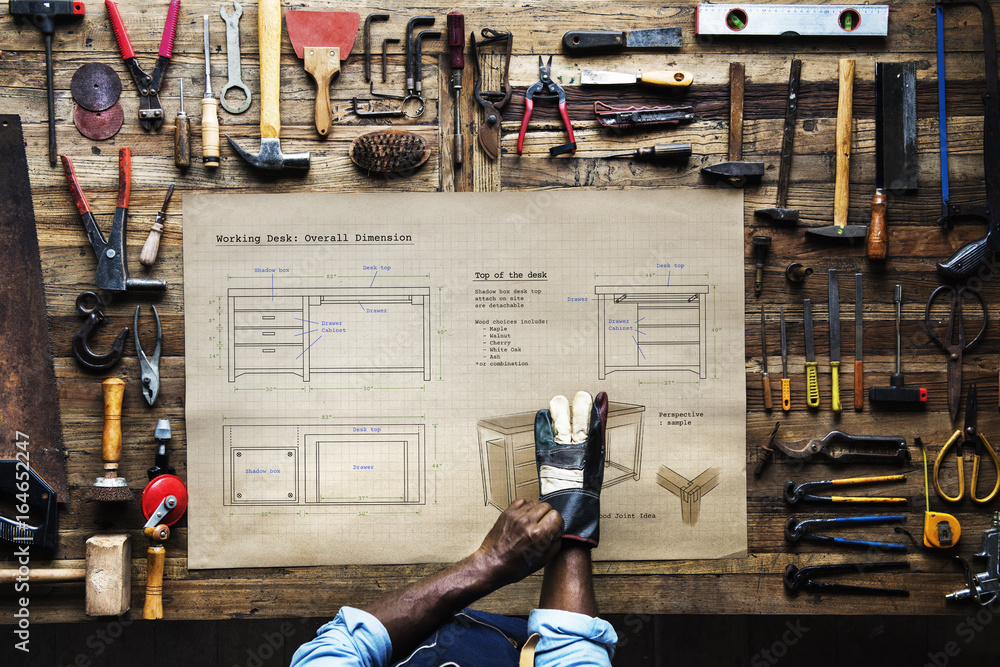 Aerial view of carpenter craftsman with furniture sketch plan