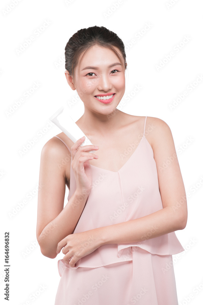 Beautiful oung woman holding tube of moisturizer, cream in hand.