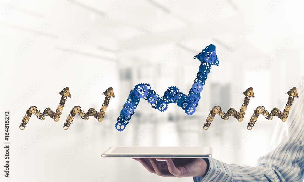 Close of businessman holding tablet pc with progressing graph ic