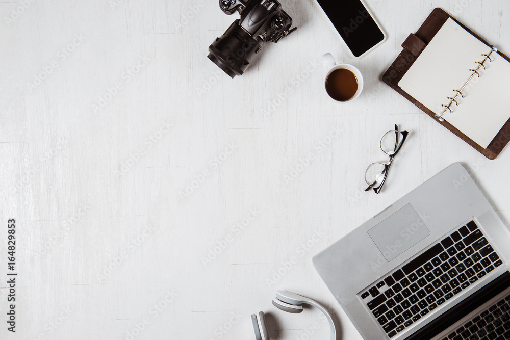 Work space for photographer, graphic designer. Flat lay of laptop, camera, colorchart, digital table