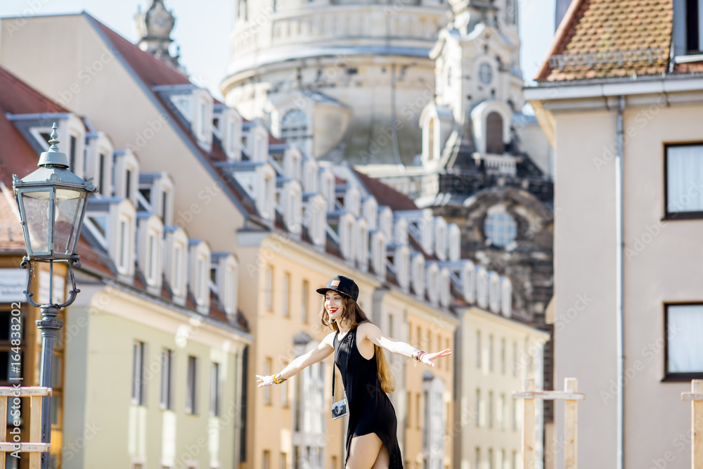 Young woman tourist walking on the famous Bruhl terrace with great view on the old town in Dresden, 