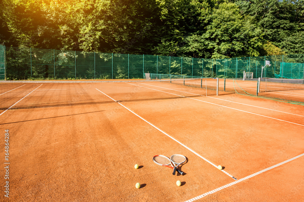 Tennis court with rackets and balls