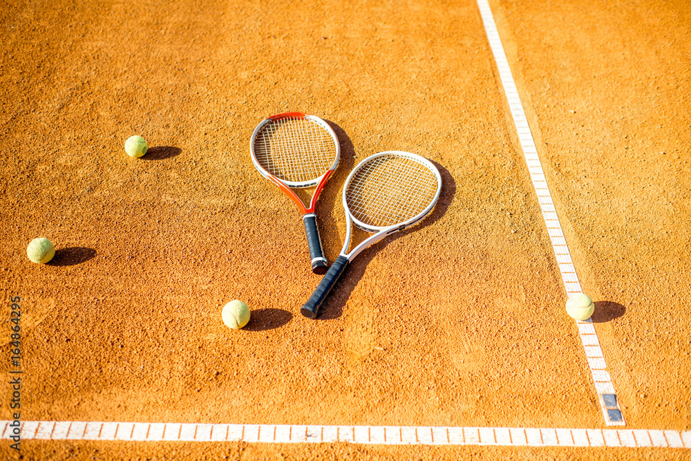 Tennis court with rackets and balls