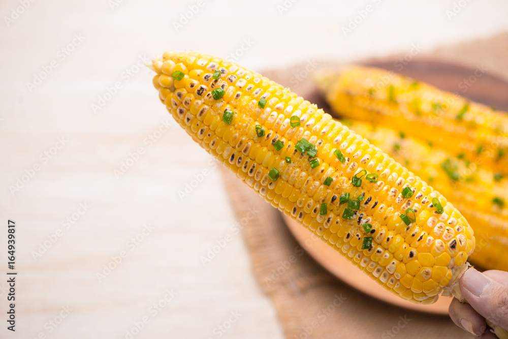 Tasty sweet grilled corn with onion sauce