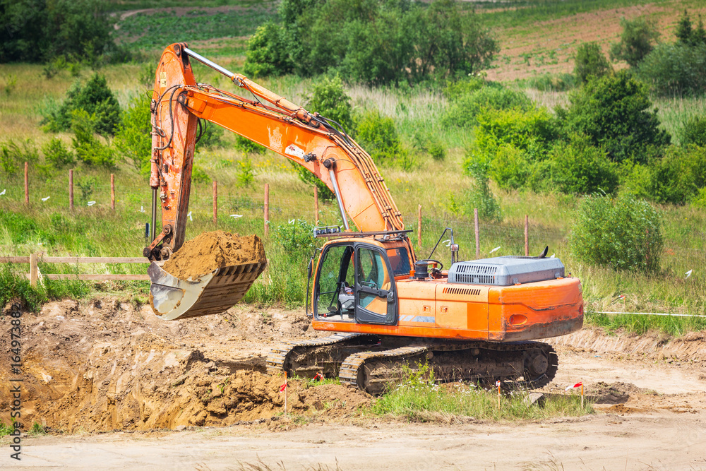 An excavator working removing ground on construction site