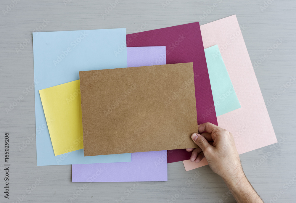 Hand Hold Showing Blank Color Paper on Gray Background