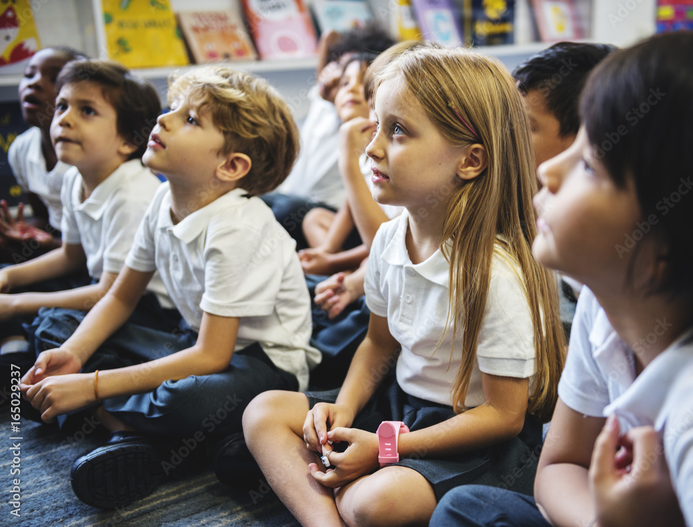 Kindergarten students sitting on the floor