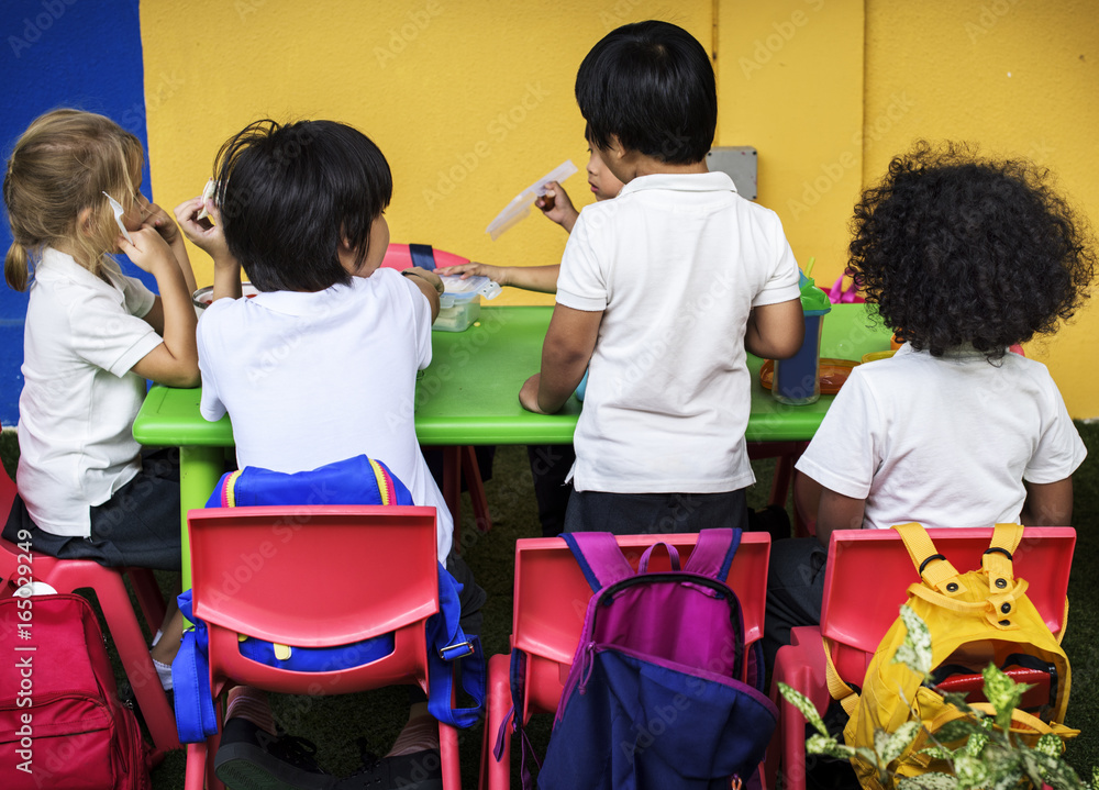 Group of Kindergarten Students Eating Food Lunch Break Together