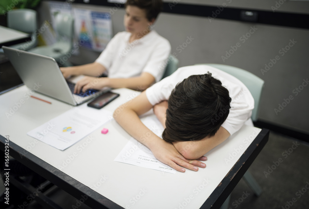 Students in uniform e-learning and sleeping