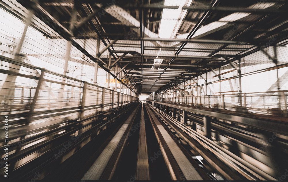 Train moving on city rail with motion blur