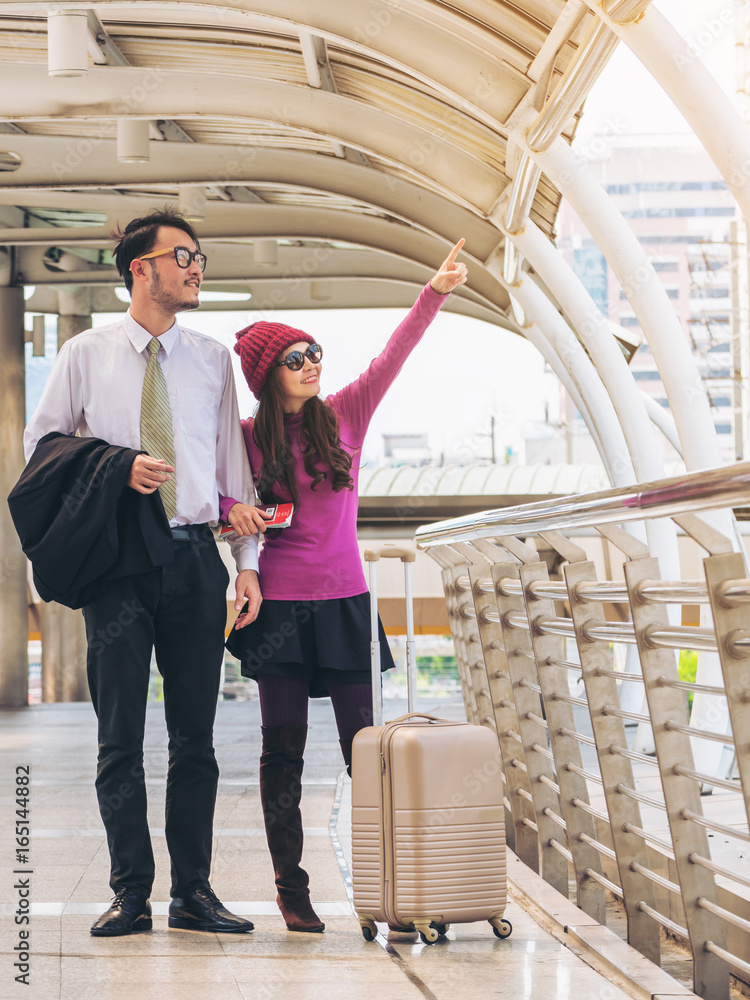 Couple travellers walking in airport walkway