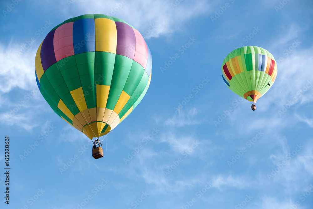 Multi colored hot air balloons in bright morning sky